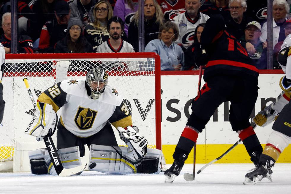 Carolina Hurricanes' Jesse Puljujarvi (13) has his shot blocked by Vegas Golden Knights goalten ...