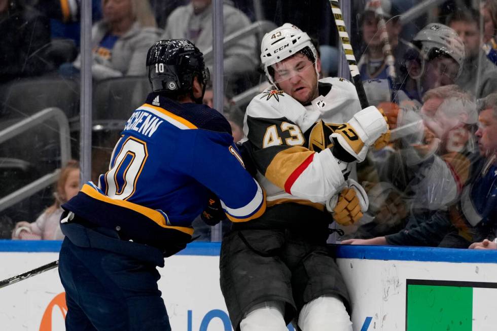 Vegas Golden Knights' Paul Cotter (43) is checked by St. Louis Blues' Brayden Schenn (10) durin ...