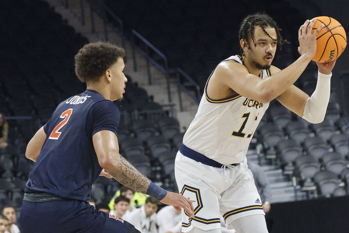 UC Irvine Anteaters forward Devin Tillis (11) looks to pass against Cal State Fullerton Titans ...