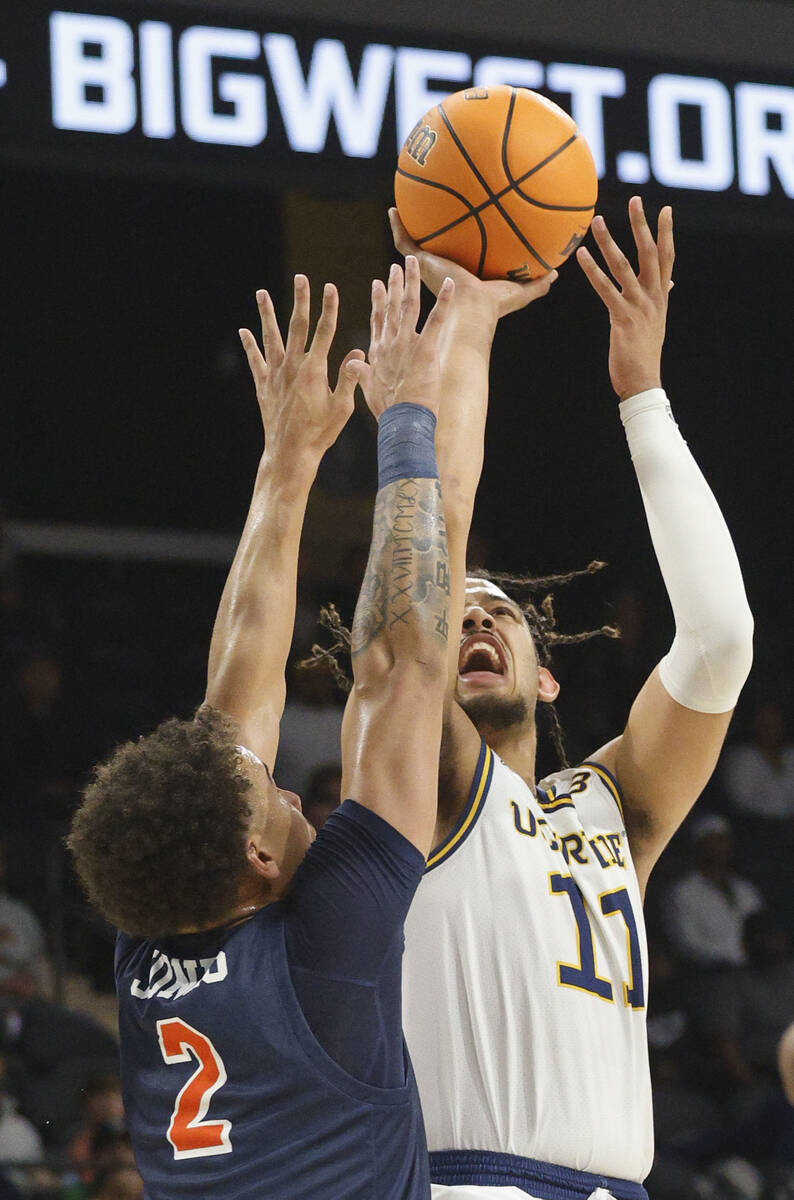 UC Irvine Anteaters forward Devin Tillis (11) attempts a jump shot as Cal State Fullerton Titan ...