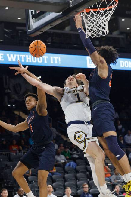 UC Irvine Anteaters guard Dawson Baker (1) attempts a jump shot as Cal State Fullerton Titans g ...