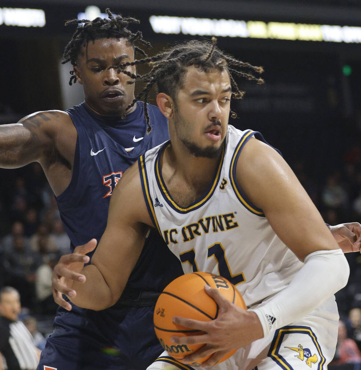 UC Irvine Anteaters forward Devin Tillis (11) looks to pass against Cal State Fullerton Titans ...