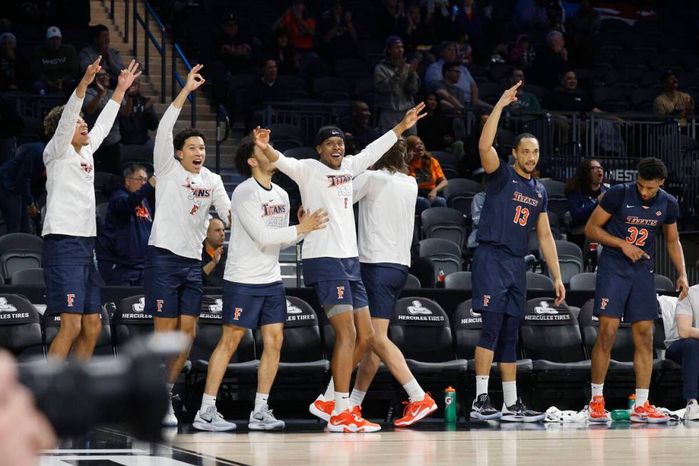 Cal State Fullerton Titans players cheer during the first half of an NCAA college basketball ga ...