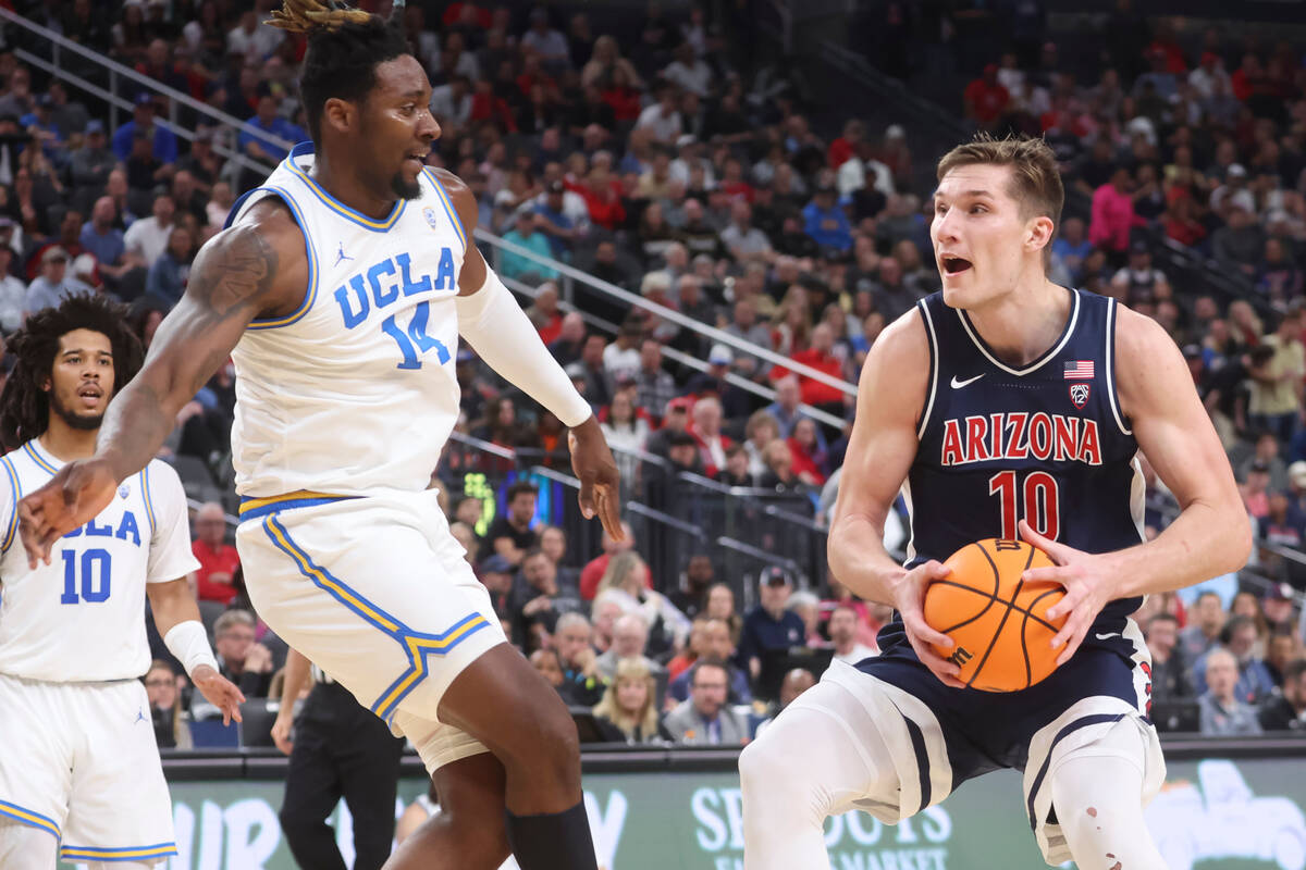 Arizona forward Azuolas Tubelis (10) drives the ball against UCLA forward Kenneth Nwuba (14) du ...