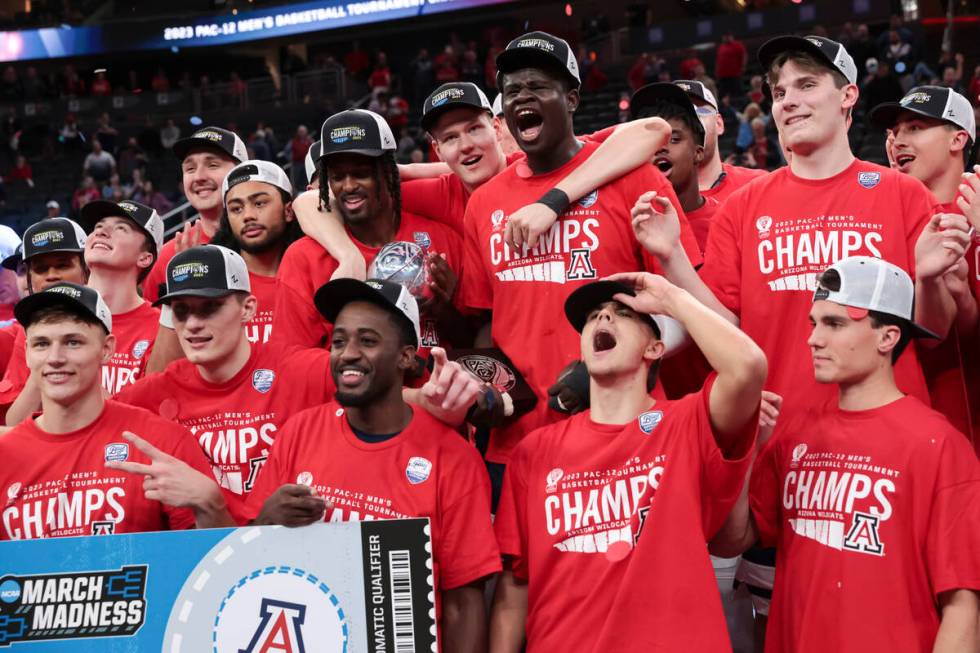 Arizona players celebrate after defeating UCLA in an NCAA college basketball game for the champ ...