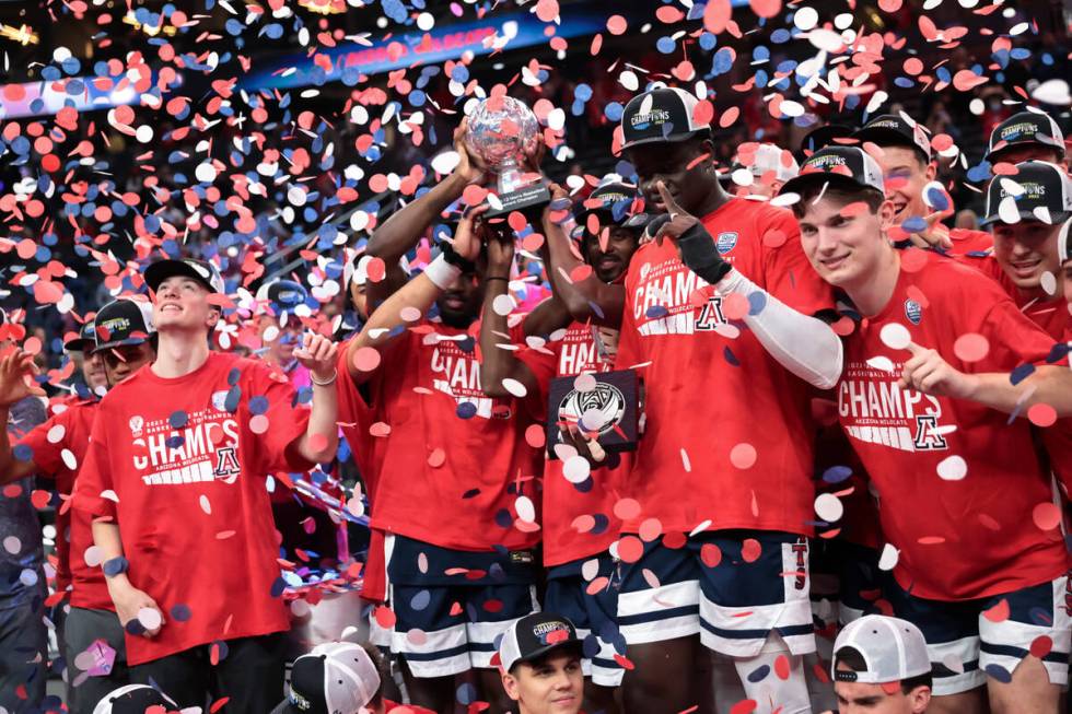 Arizona players celebrate after defeating UCLA in an NCAA college basketball game for the champ ...