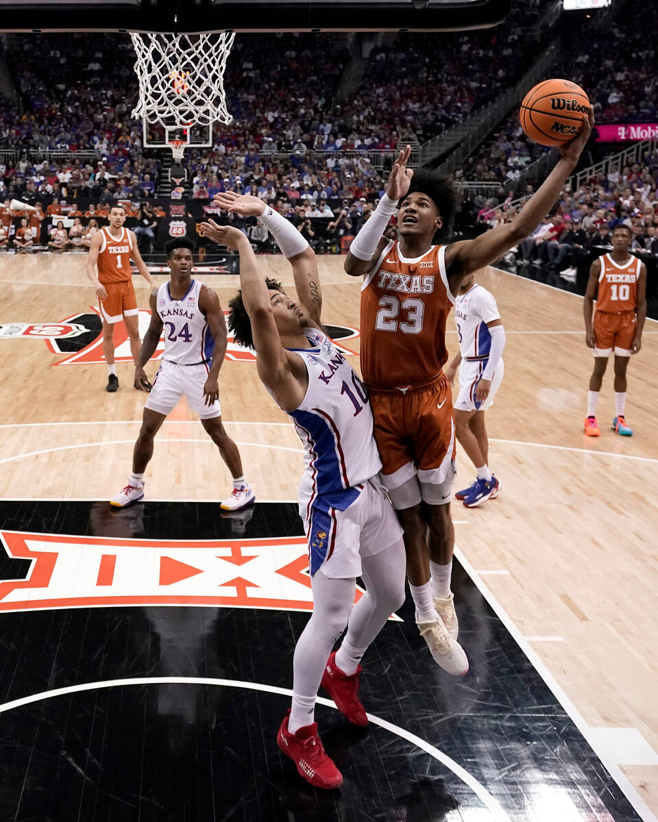 Texas forward Dillon Mitchell (23) shoots over Kansas forward Jalen Wilson (10) during the firs ...