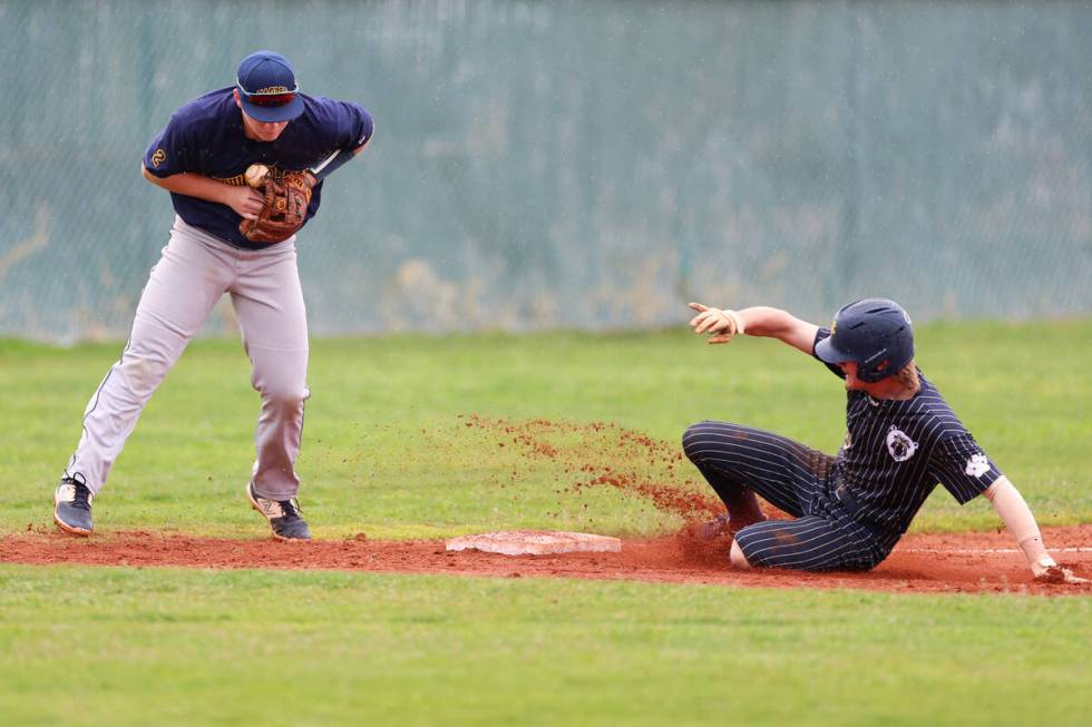 Spring Valley's Jackson Rieckmann (9) slides safe to second base as Boulder City's Jeremy Spenc ...