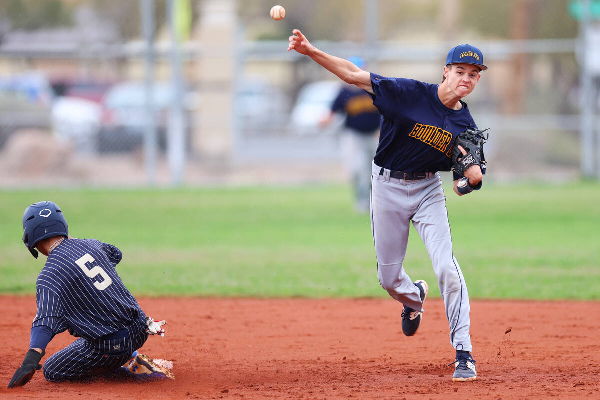 Boulder City's Isaac Gibson (6) throws the ball to first base for a double play during a spring ...