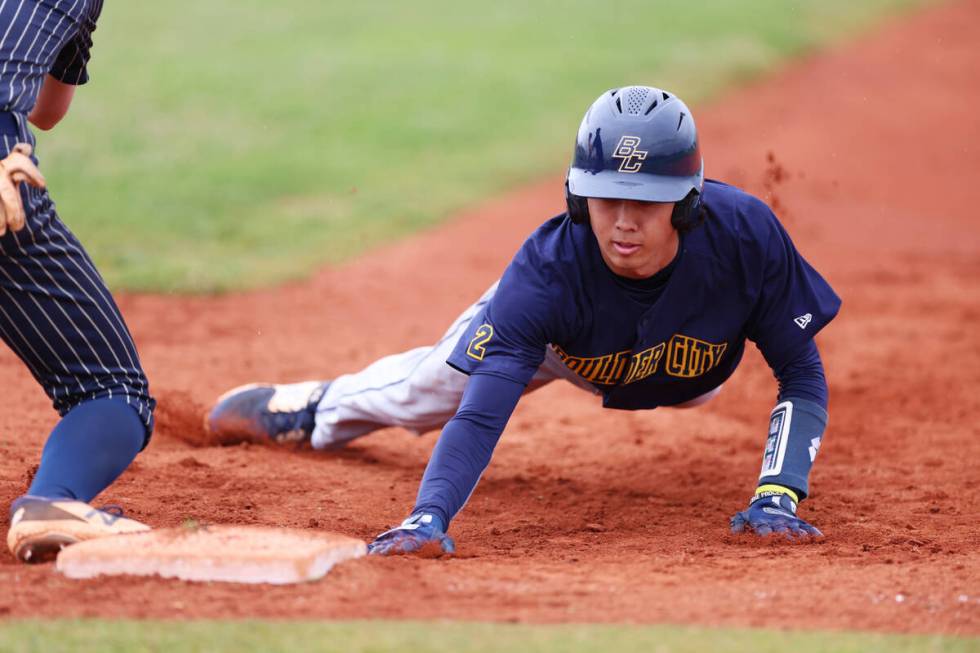 Boulder City's Landon Baker (46) slides back to first day safely after a check by a Spring Val ...