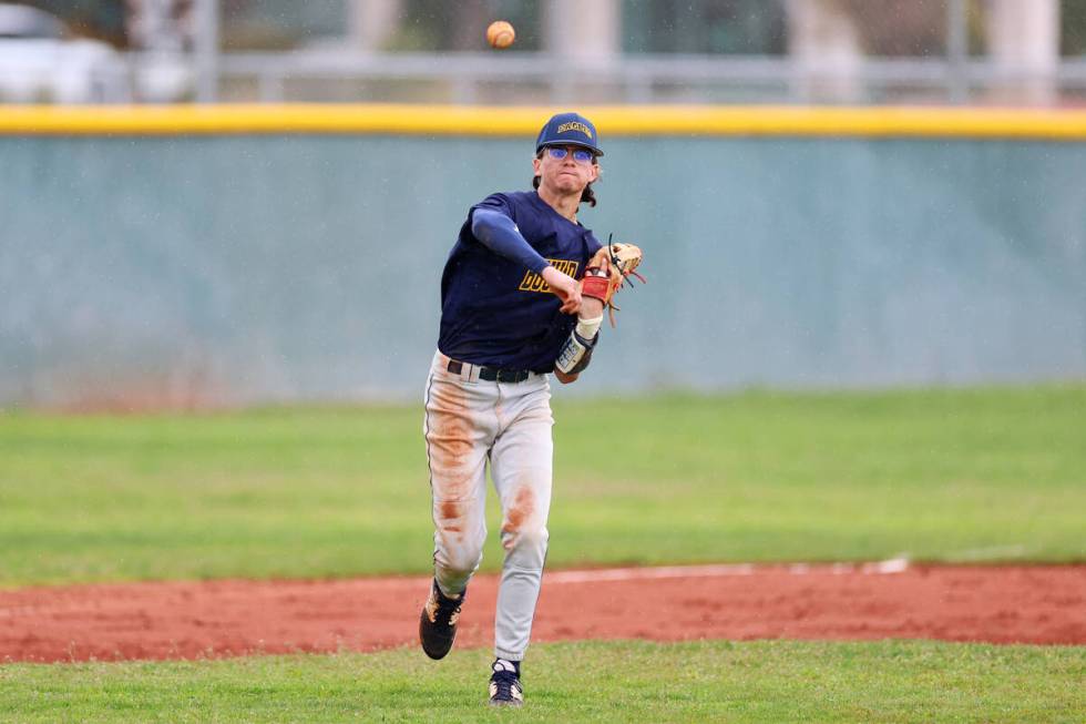 Boulder City's Derek Render (1) throws the ball to first base for an out during a spring break ...