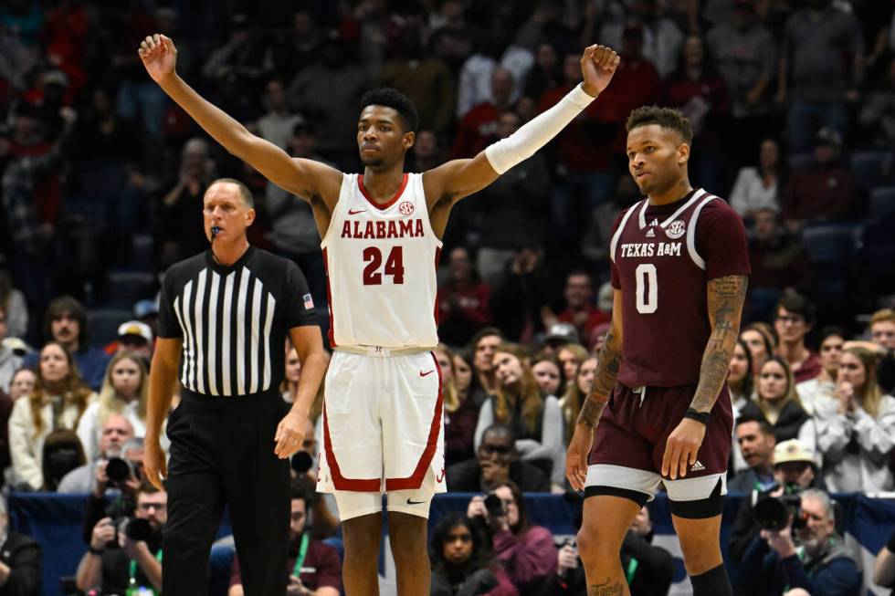 Alabama forward Brandon Miller (24) reacts as Texas A&M guard Dexter Dennis (0) looks on in ...