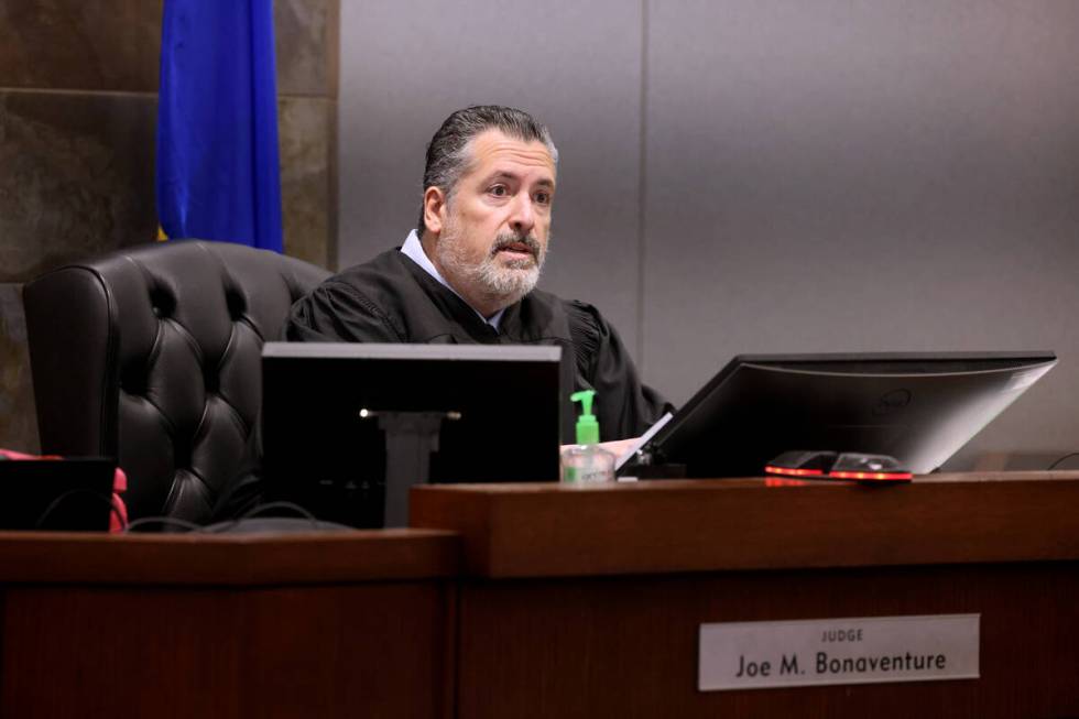 Justice of the Peace Joe Bonaventure talks with attorneys for former Raiders player Henry Ruggs ...