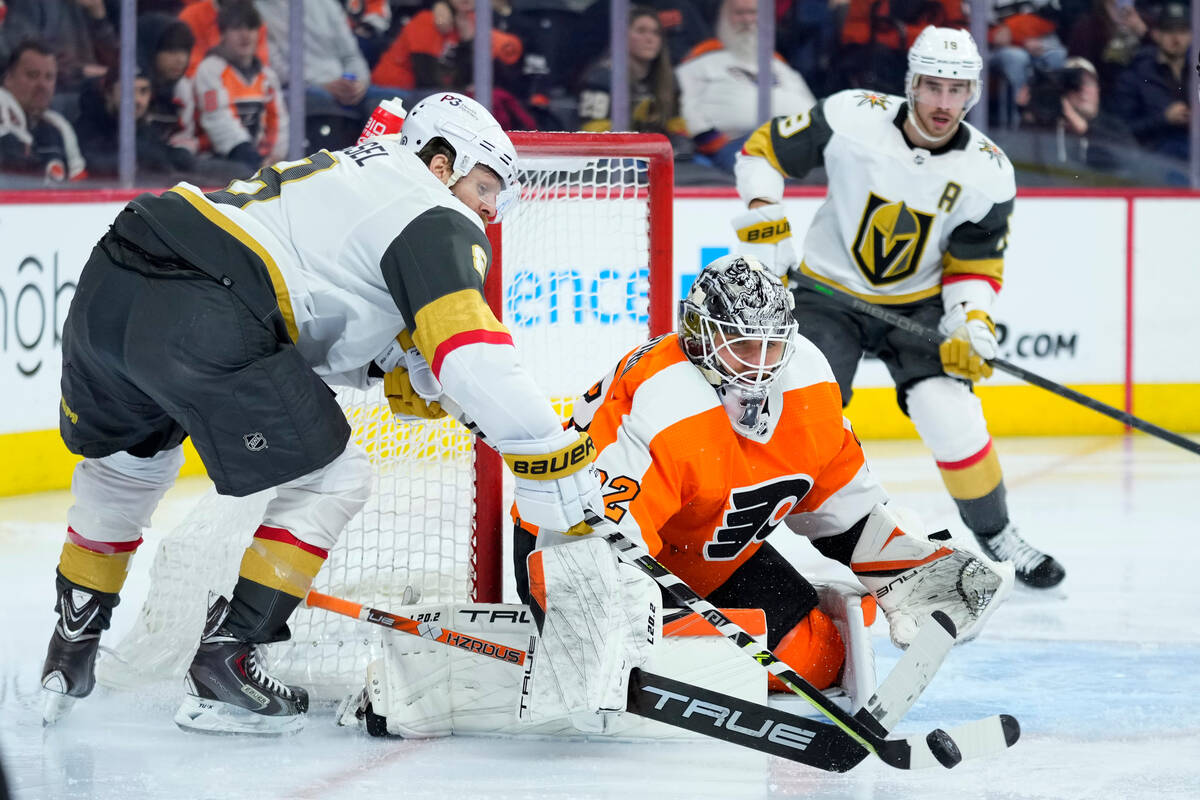 Vegas Golden Knights' Phil Kessel, left, tries to score against Philadelphia Flyers' Felix Sand ...