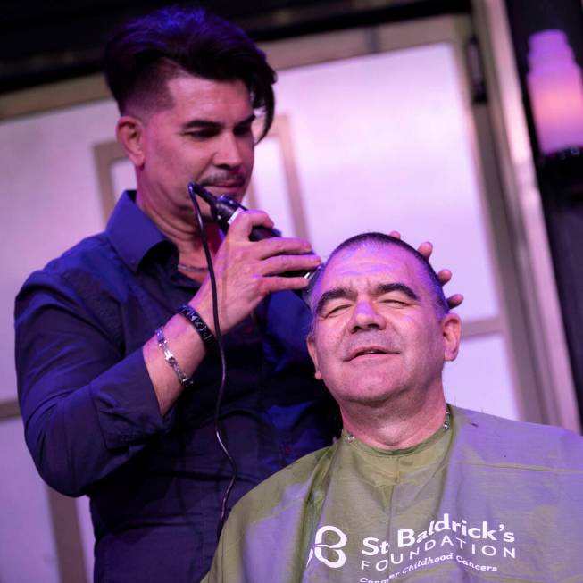 Stylist Tony Torres shaves Review-Journal columnist John Katsilometes’ head to support S ...