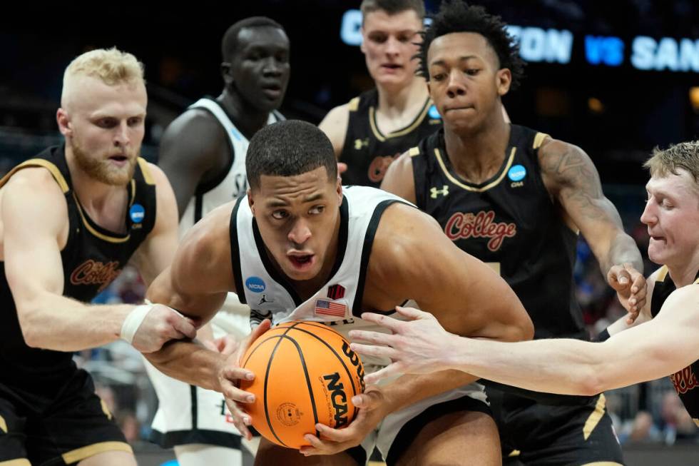 San Diego State forward Jaedon LeDee (13) is surrounded by Charleston guard Dalton Bolon (3), f ...