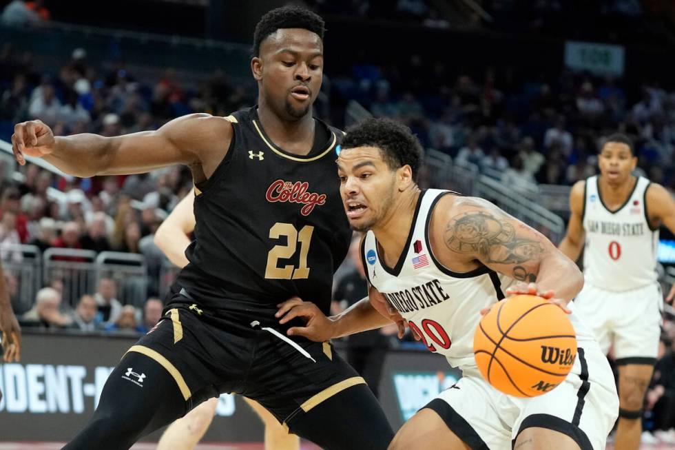 San Diego State guard Matt Bradley (20) gets around Charleston guard Jaylon Scott (21) during t ...