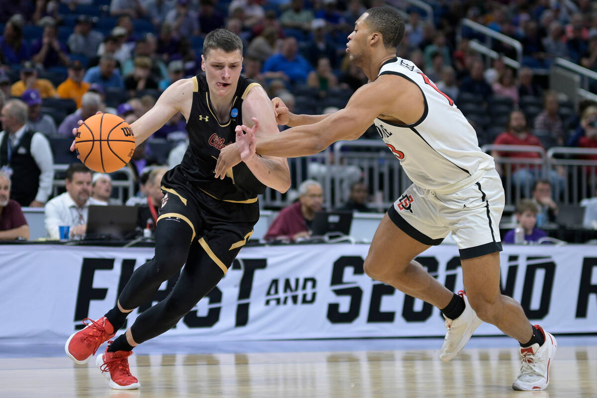 Charleston forward Ante Brzovic, left, drives as San Diego State forward Jaedon LeDee (13) defe ...