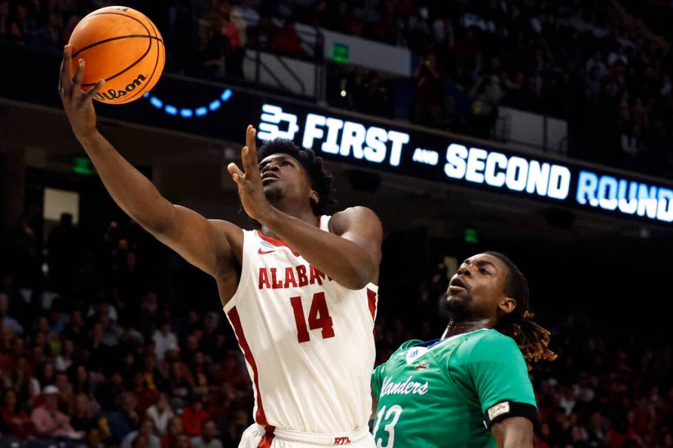 Alabama center Charles Bediako (14) lays in a basket as Texas A&M Corpus Christi forward De ...