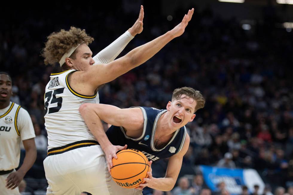 Utah State guard Sean Bairstow (2) ducks around Missouri forward Noah Carter (35) during the fi ...