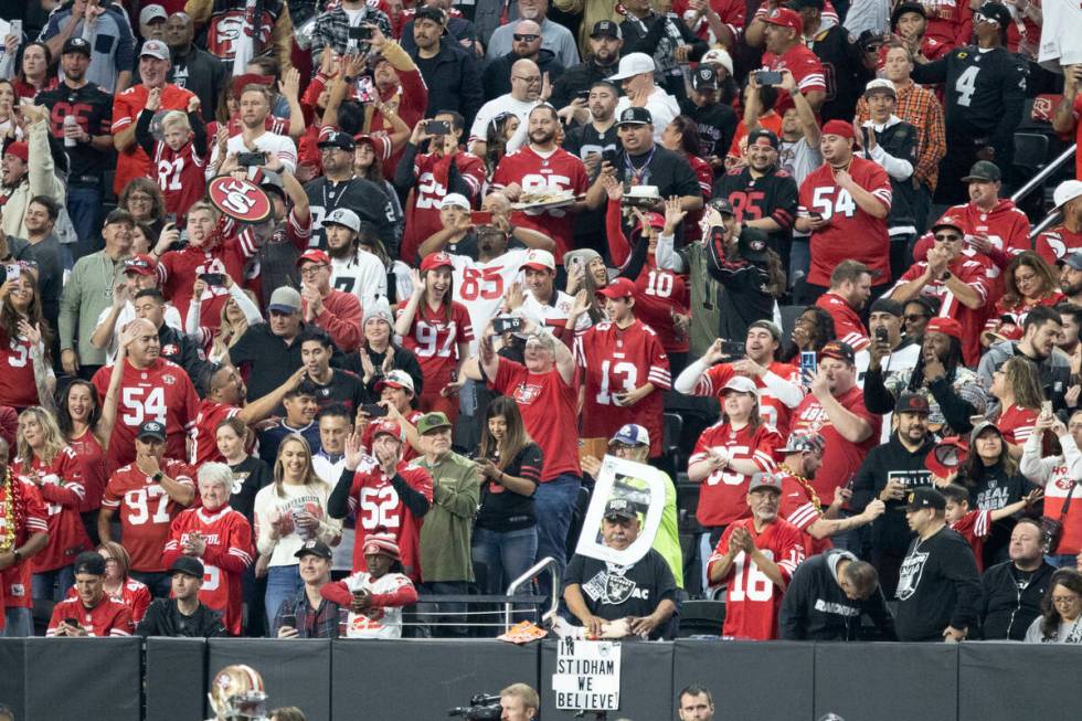 A sea of San Francisco 49ers fans take over a section in Allegiant Stadium for an NFL game agai ...