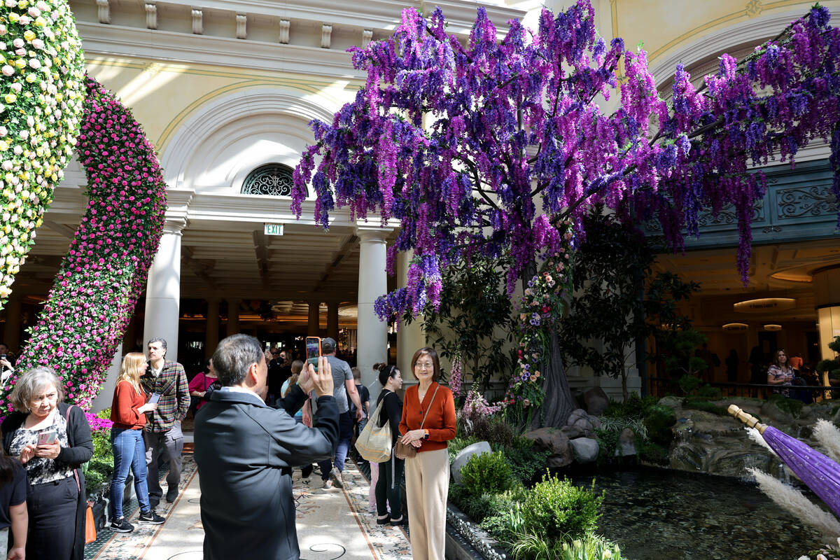 Guests take in the new spring display, “Giardino Dell’ Amore,” at the Bell ...