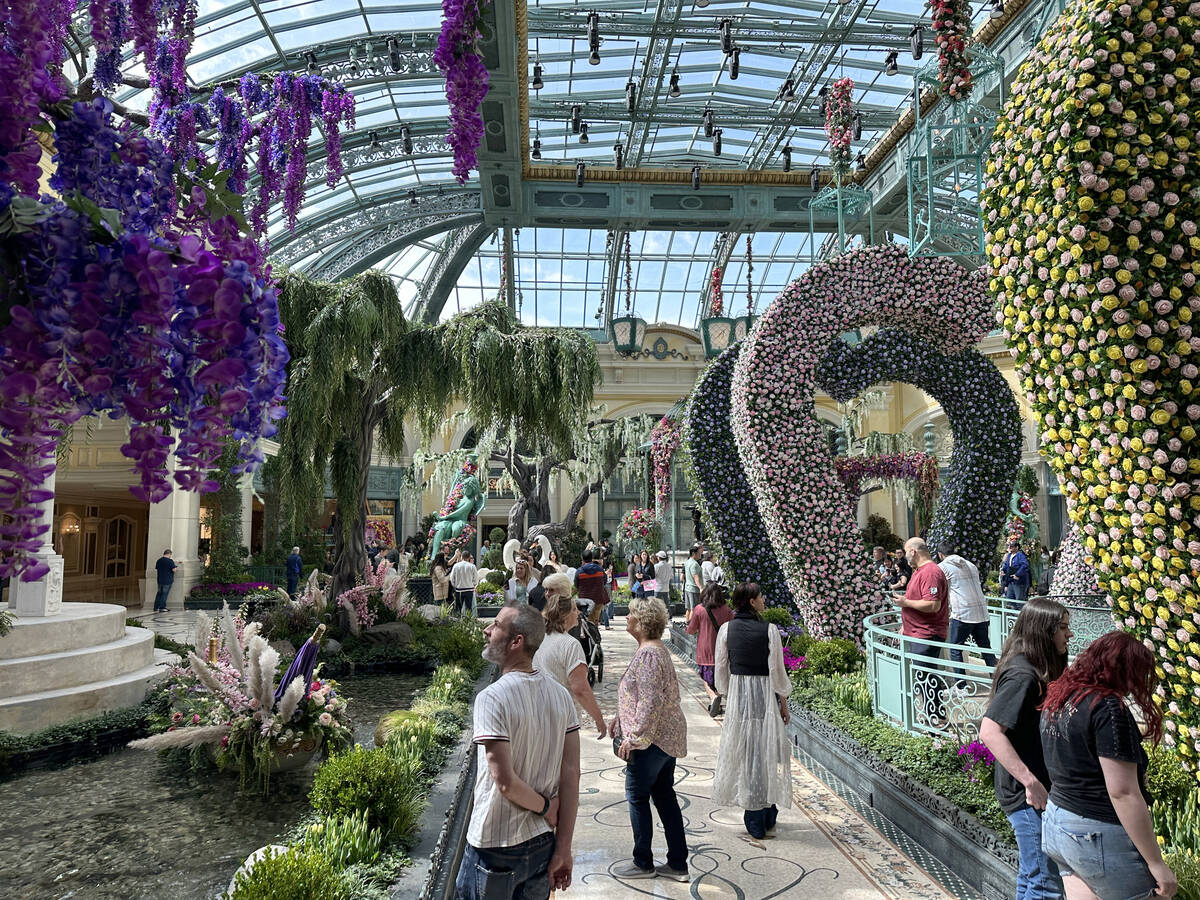 Guests take in the new spring display, “Giardino Dell’ Amore,” at the Bell ...