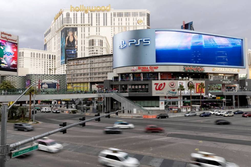 Traffic travels in the intersection of Las Vegas Boulevard and Harmon Avenue past Harmon Corner ...