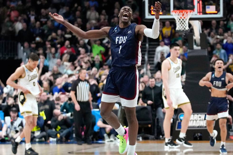 Fairleigh Dickinson guard Joe Munden Jr. (1) celebrates beating Purdue 63-58 after a first-roun ...