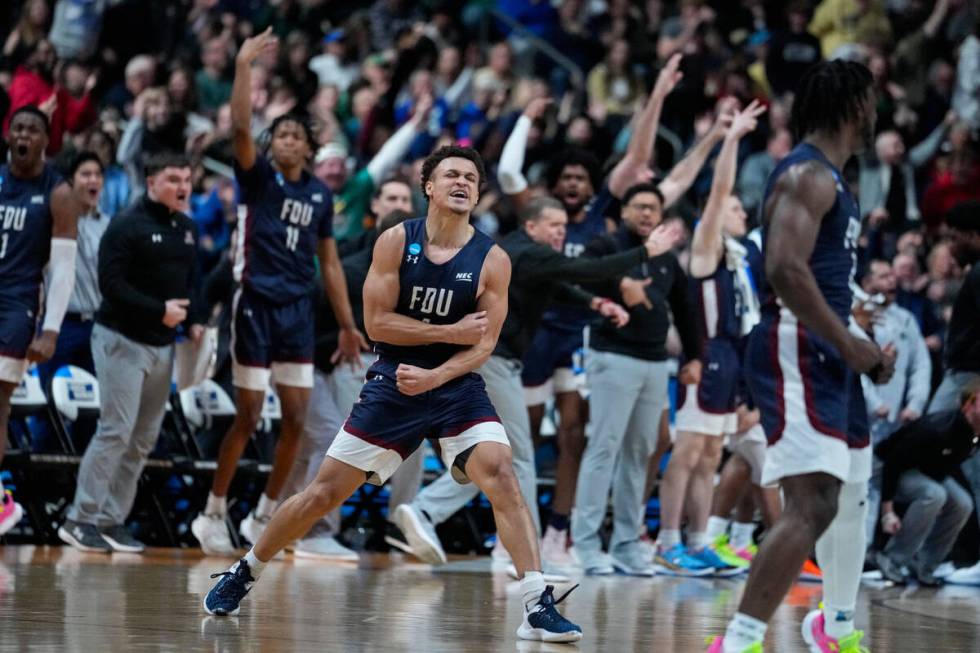 Fairleigh Dickinson guard Grant Singleton (4) celebrates after a basket against Purdue in the s ...