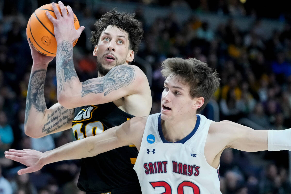 Virginia Commonwealth's Brandon Johns Jr. (30) shoots against St. Mary's Aidan Mahaney (20) in ...