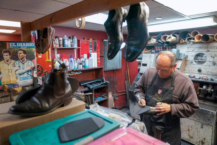 An employee repairs a pair of women's shoes at the Alpha Shoe Repair Corp., Friday, Feb. 3, 202 ...