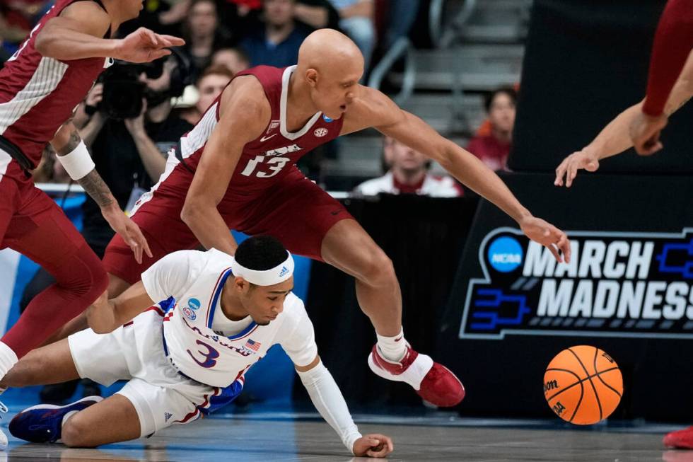 Arkansas guard Jordan Walsh (13) fights for a loose ball with Kansas guard Dajuan Harris Jr. (3 ...