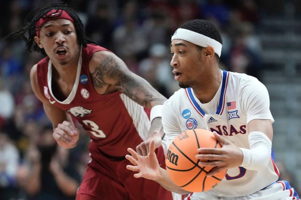 Kansas' Dajuan Harris Jr. grabs a loose ball in front of Arkansas' Nick Smith Jr. during the fi ...