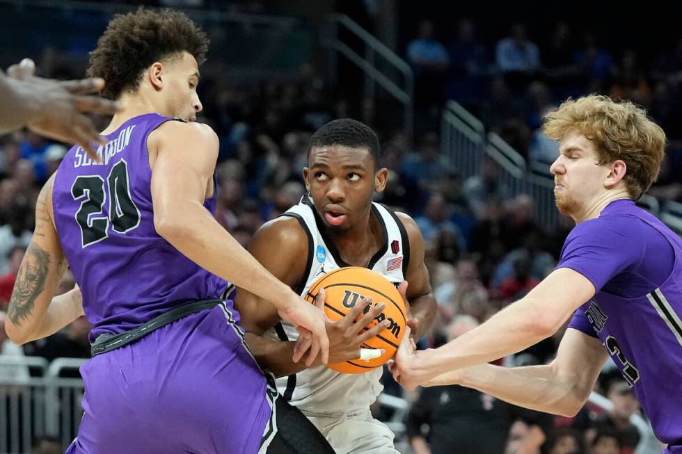 San Diego State guard Lamont Butler (5) cuts between Furman forward Jalen Slawson (20) and forw ...