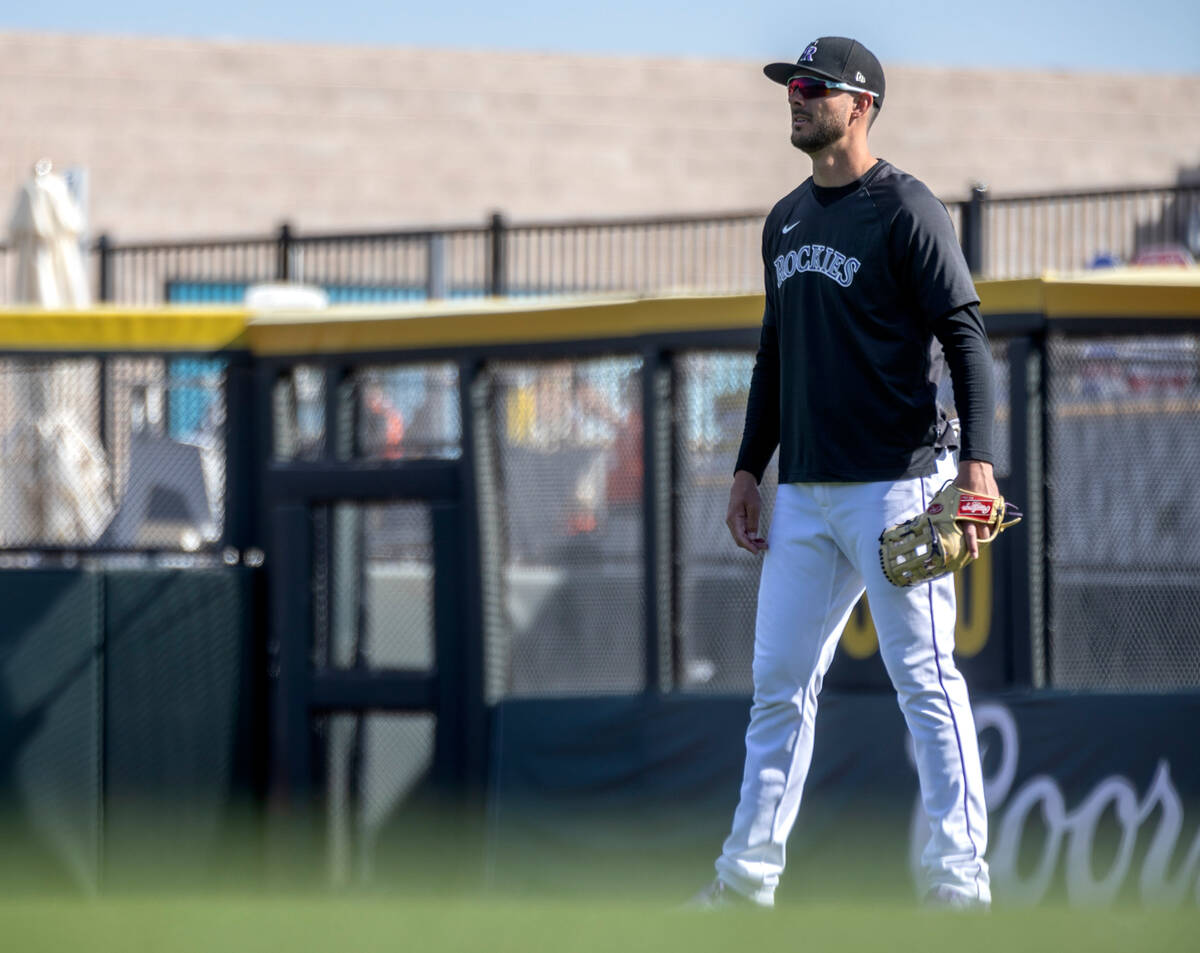 Kris Bryant of the Colorado Rockies anticipates the ball during practice before an MLB exhibiti ...