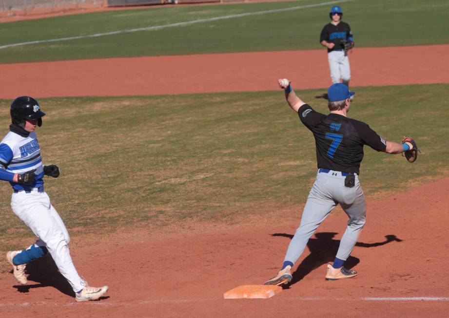 Basic's Koa Won (4) gets tagged out by Green Valley's Brady Ballinger (7) at first base during ...