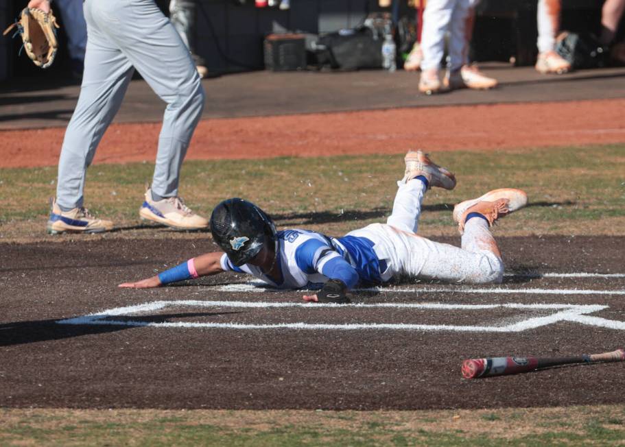 Basic’s Troy Southisene scores a run against Green Valley during a baseball game at Basi ...