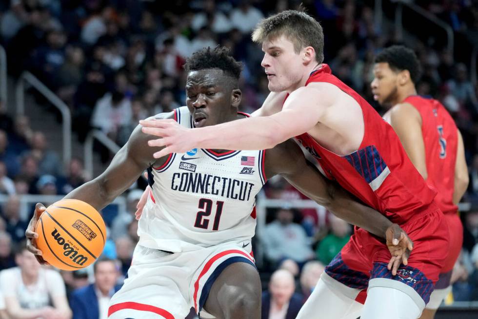 UConn's Adama Sanogo (21) drives against Saint Mary's Mitchell Saxen, right, in the second half ...