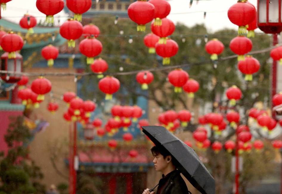 Rain falls in Chinatown in Los Angeles as an atmospheric river brings heavy rain to Southern Ca ...