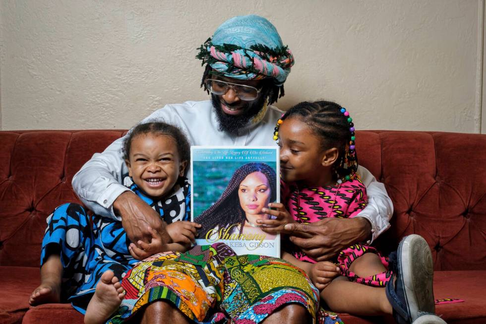 In this photo provided by Henry Danner, Omari Maynard sits with his children, Khari, left, and, ...