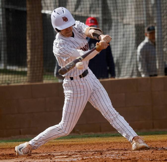 Desert Oasis' Porter Brunn (26) connects with the ball during the first inning of a baseball ga ...