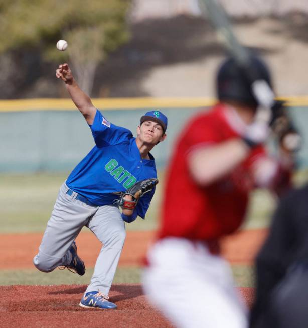 Green Valley's Bridger Knudson (8) delivers to Las Vegas' Gage McGown (13) during the second in ...