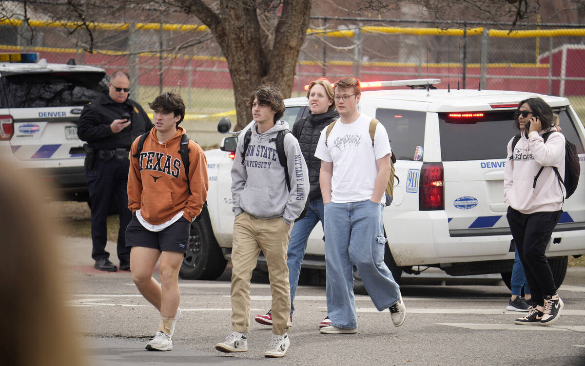 Students are walked out of East High School following a shooting, Wednesday, March 22, 2023, in ...