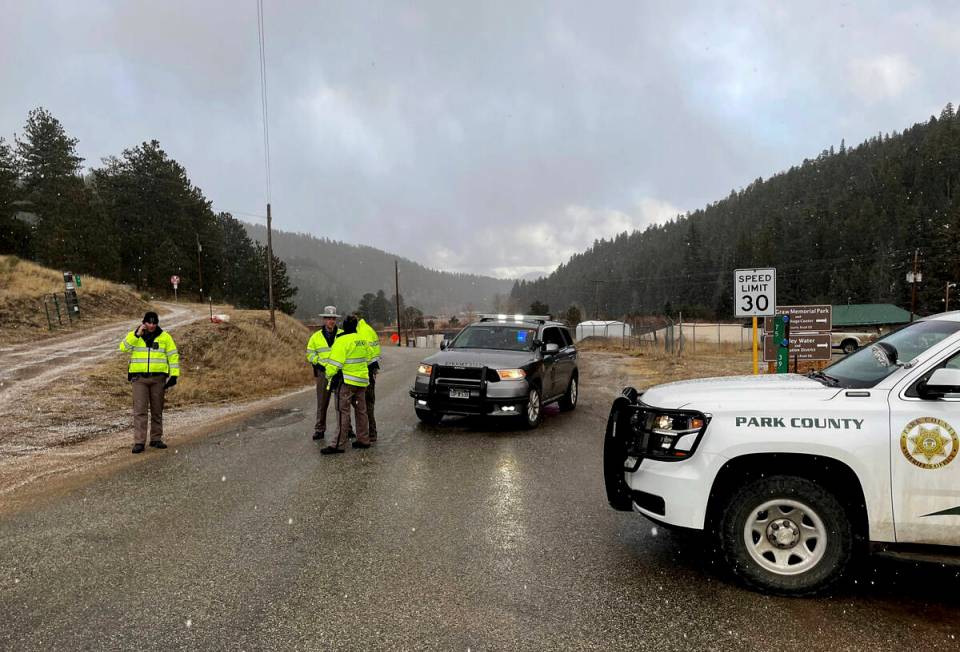 Sheriff deputies block a road in the town of Bailey, Colo., where authorities found an abandone ...