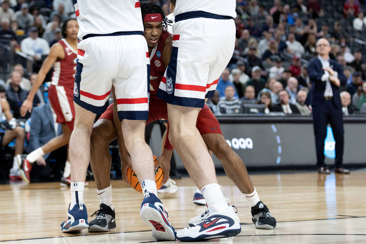 Arkansas Razorbacks forward Jalen Graham (11) struggles to find a way past Connecticut Huskies ...