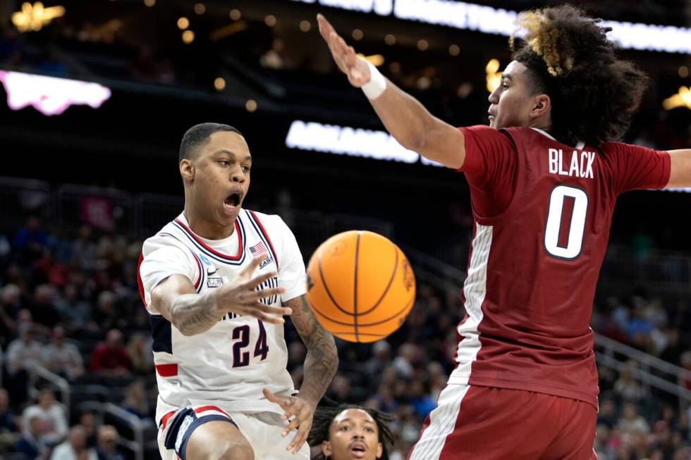 Connecticut Huskies guard Jordan Hawkins (24) passes around Arkansas Razorbacks guard Anthony B ...