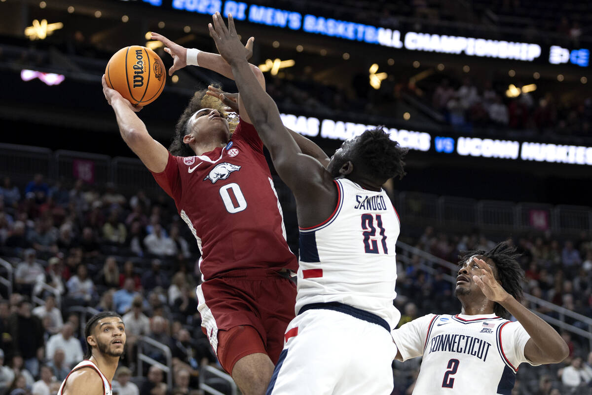 Arkansas Razorbacks guard Anthony Black (0) shoots against Connecticut Huskies forward Adama Sa ...