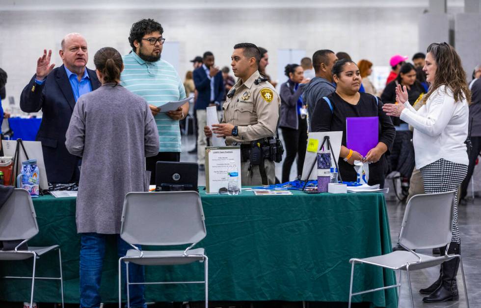 Job seekers speak to staff from the Metropolitan Police Department during the annual Spring Job ...