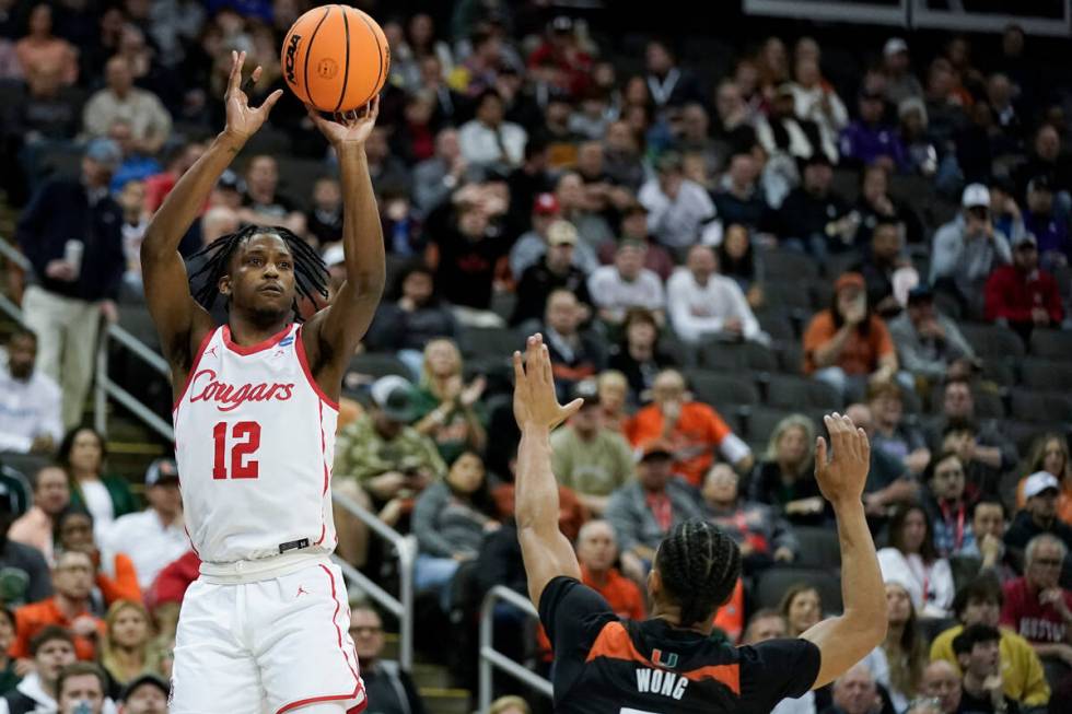 Houston guard Tramon Mark shoots over Miami guard Isaiah Wong in the first half of a Sweet 16 c ...